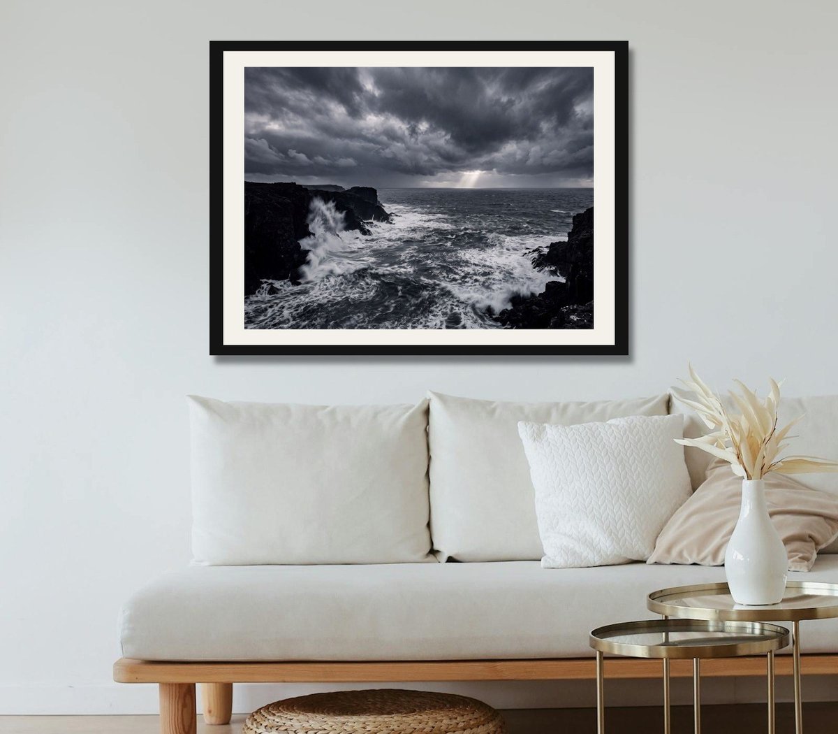 Stormy Coast, a near-monochrome storm-sea print, framed on the wall of a calm neutral lounge